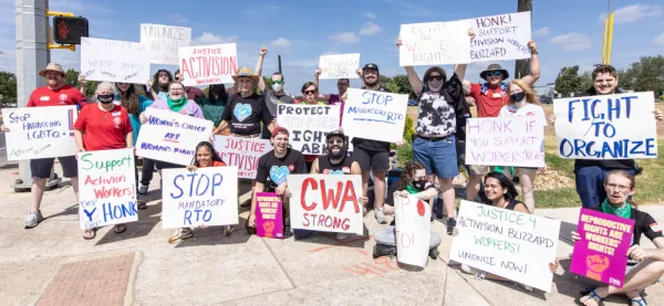 Photo of CWA members at an action holding signs