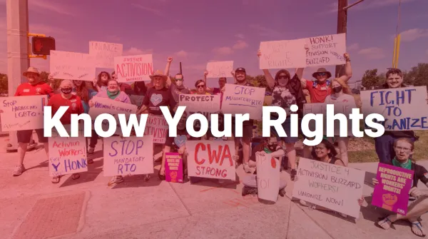 Photo of CWA members at an action holding signs with the title "Know Your Rights".