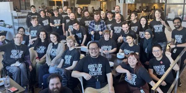 Photo of CWA members at Google w/ shirts reading "Googles for job security"
